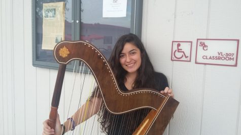 Adriana Patino with her harp at the talent show.