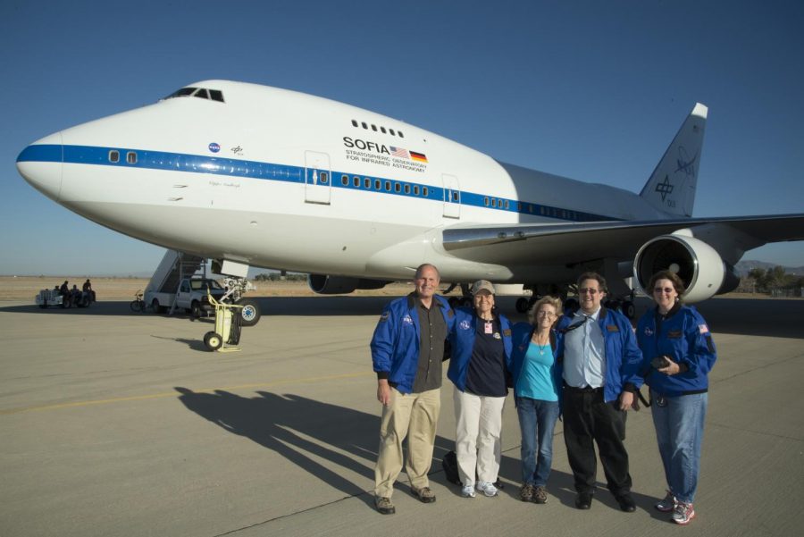 A photograph of Clifford Gerstman and Susan Groff in front of the SOFIA plane.