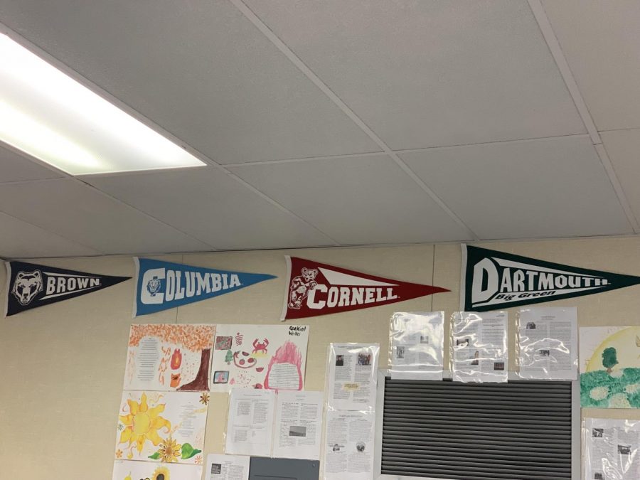 Photograph of college pendants on a classroom wall at Middle College High School. 