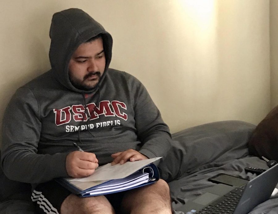 College student Francisco Guerrero, who is also this reporter's brother, completes his schoolwork from home due to the switch to online classes.