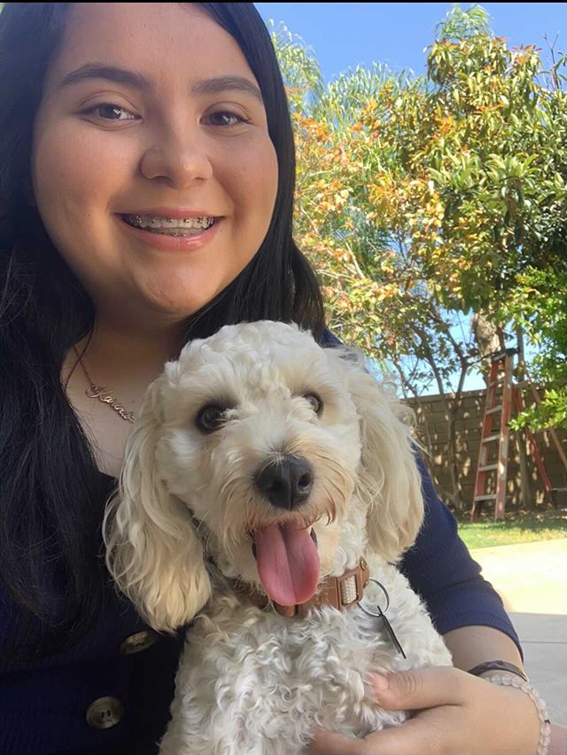 Senior Karina Romero spends time with her puppy to relieve stress and have fun.