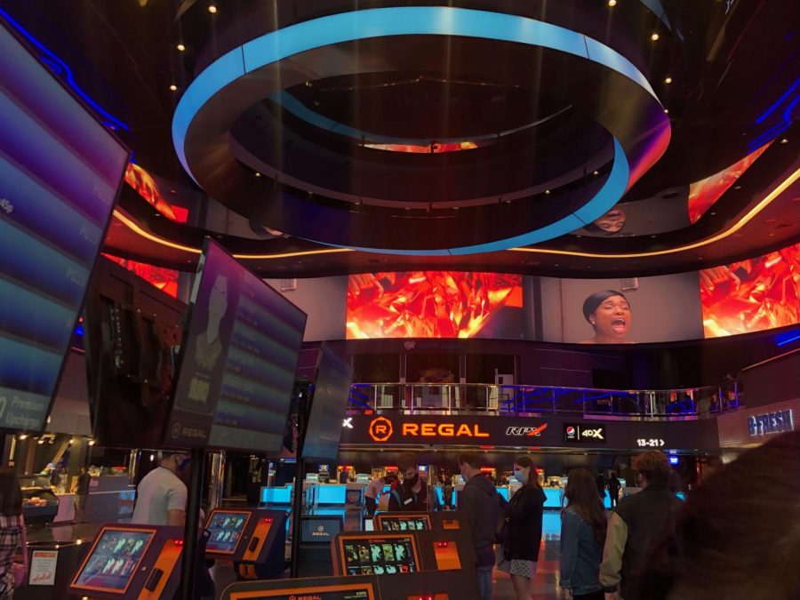 Regal Irvine Spectrum movie theaters renovation features immersive digital movie posters as well as self serving ticket booths.