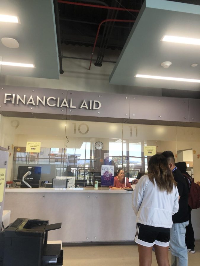 Students at Santa Ana College wait in line at the financial aid office which guides them through federal and state student aid programs that help make education more affordable.