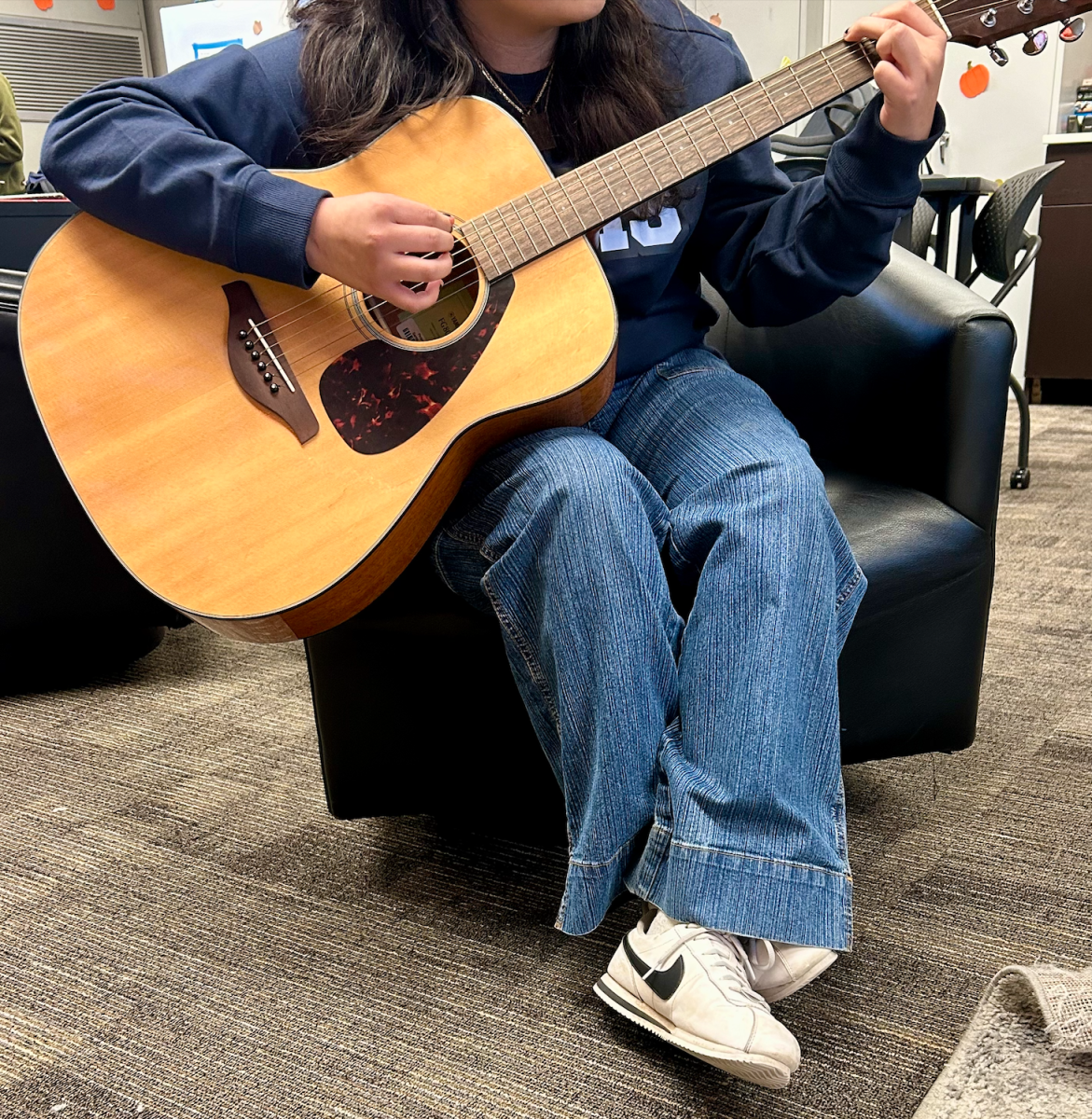 Belen Estrada serenades her friends with a song—La Llorona—she recently learned on the guitar, at the school lounge.