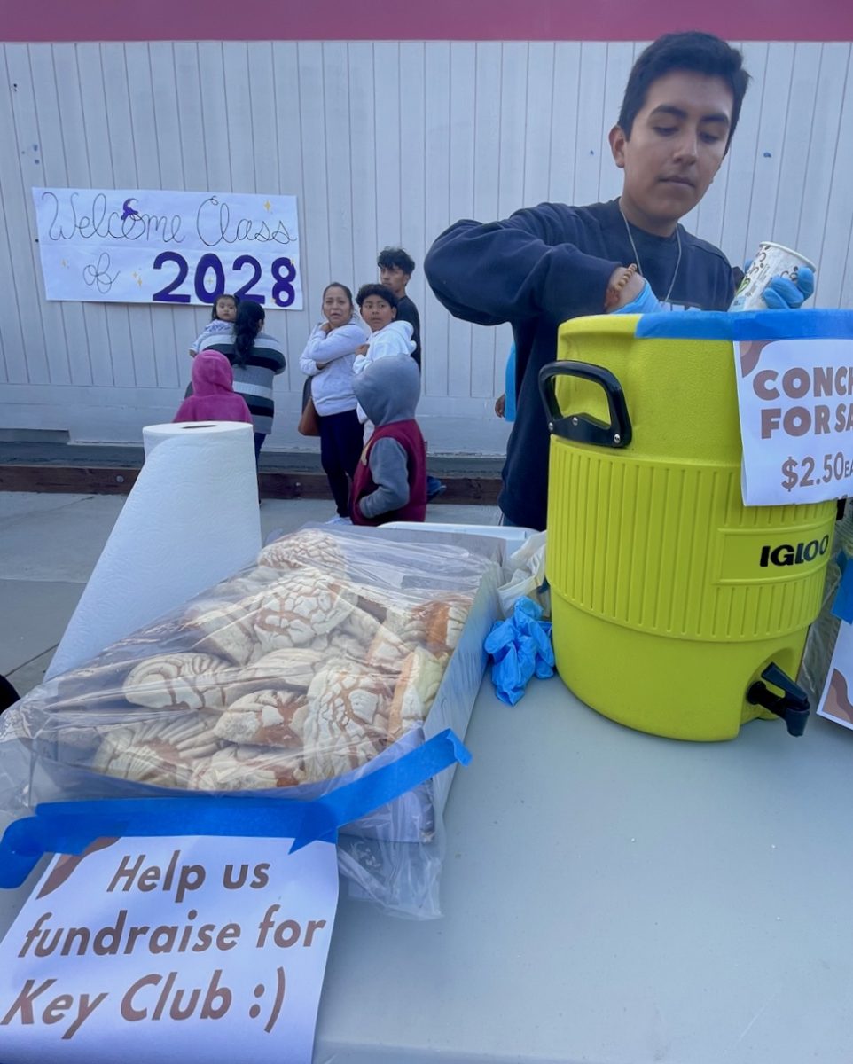 Anthony Nuñez sells pan dulce and champurrado with Paola Sanchez to create funds for MCHS Key Club official recognition. 