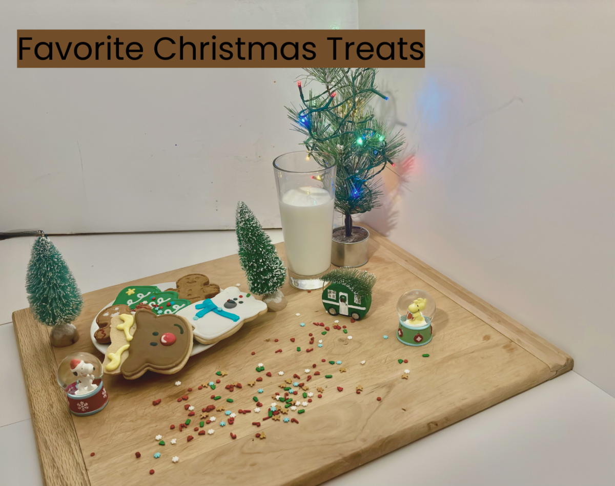 A plate of Christmas treats (specifically cookies) with a warm glass of milk surrounded by Christmas decor ready for Santa