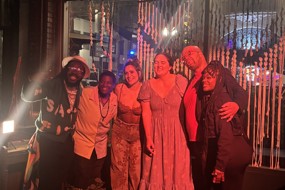 The top 4 competitors (in the middle) of the OC Poetry Slam competition pose after qualifying to represent Orange County in regional & national competitions.